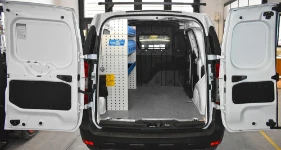 Estantería del lado izquierdo con panel perforado y cajas en el Dacia Dokker